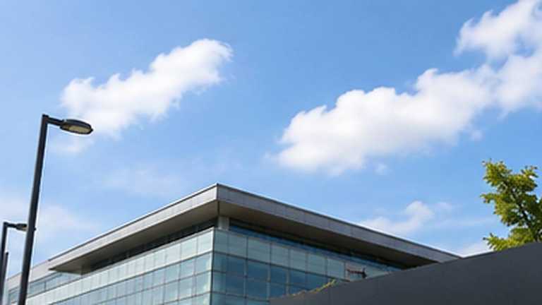 Bright realistic editorial view of a modern Korean semiconductor campus in daylight